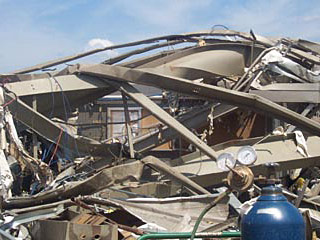 An F4 tornado wrecked a manufacturing plant in Roanoke, Ill., July 13, 2004, but a timely warning, a NOAA Weather Radio receiver, a prepared workforce, and reinforced shelters kept as many as 140 plant workers from harm. Source: www.noaa.gov